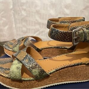 Snake skin pattern sandals with metallic accents. Core bottom, zip ups.